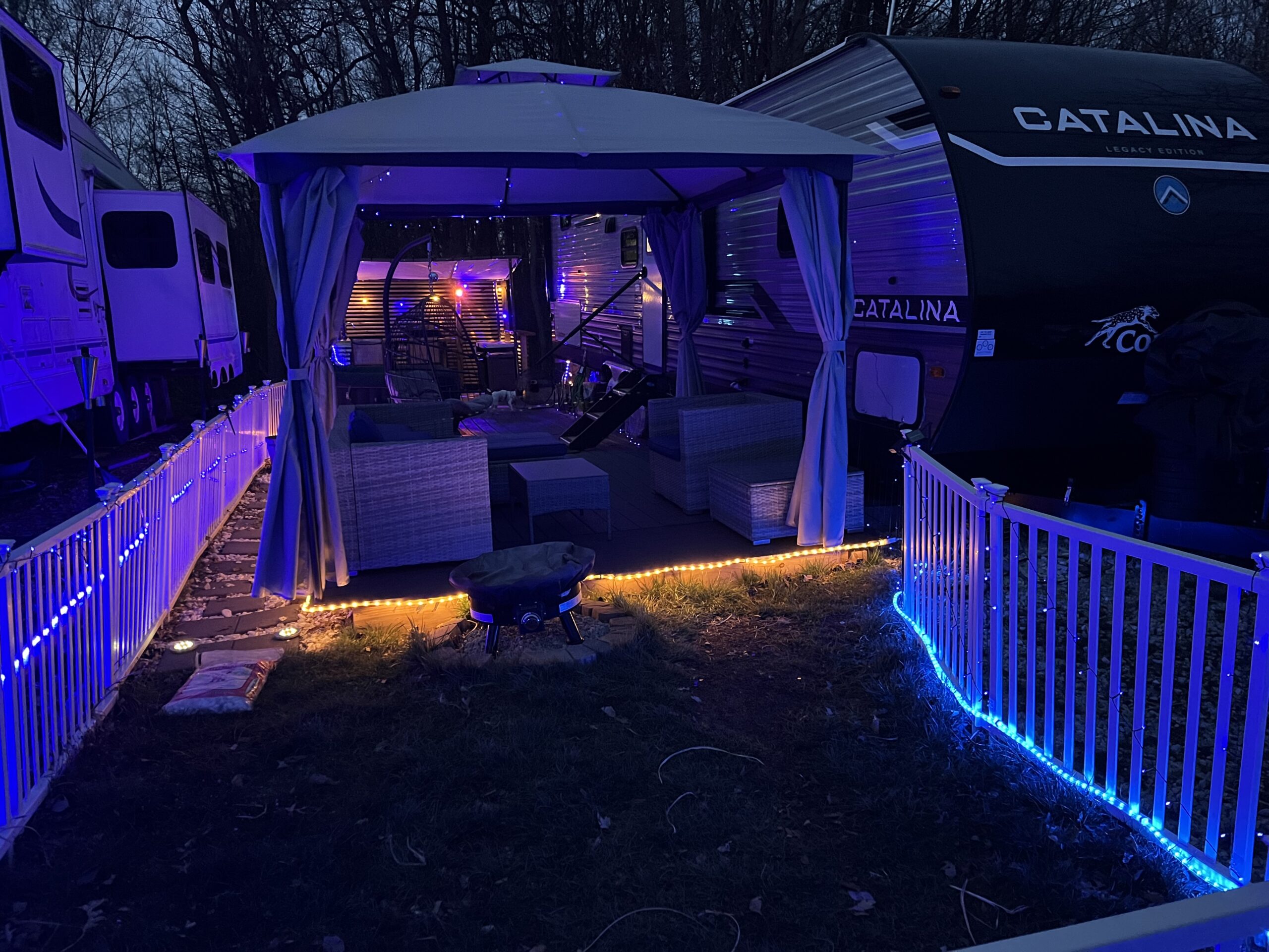 36' Coachmen Catalina Legacy Edition with outdoor living room lighting at night